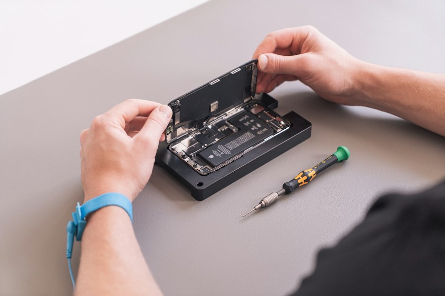 Sample image of hands working on a device; not Phone Care Jervis staff